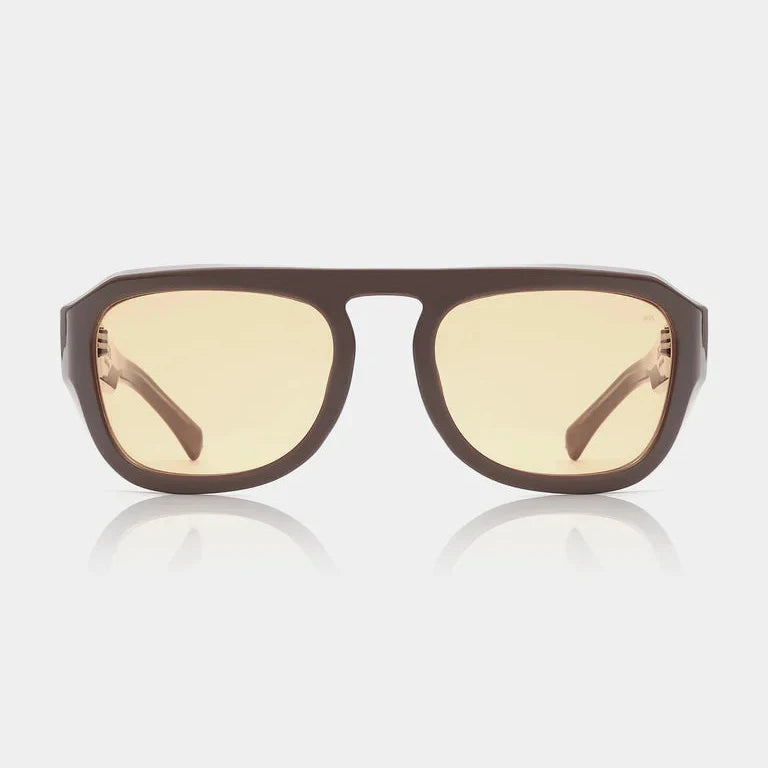 Sunglasses with brown frame and yellow-tinted lenses on a white background