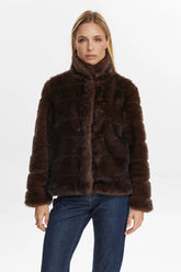 Woman wearing a brown fur coat on a white background