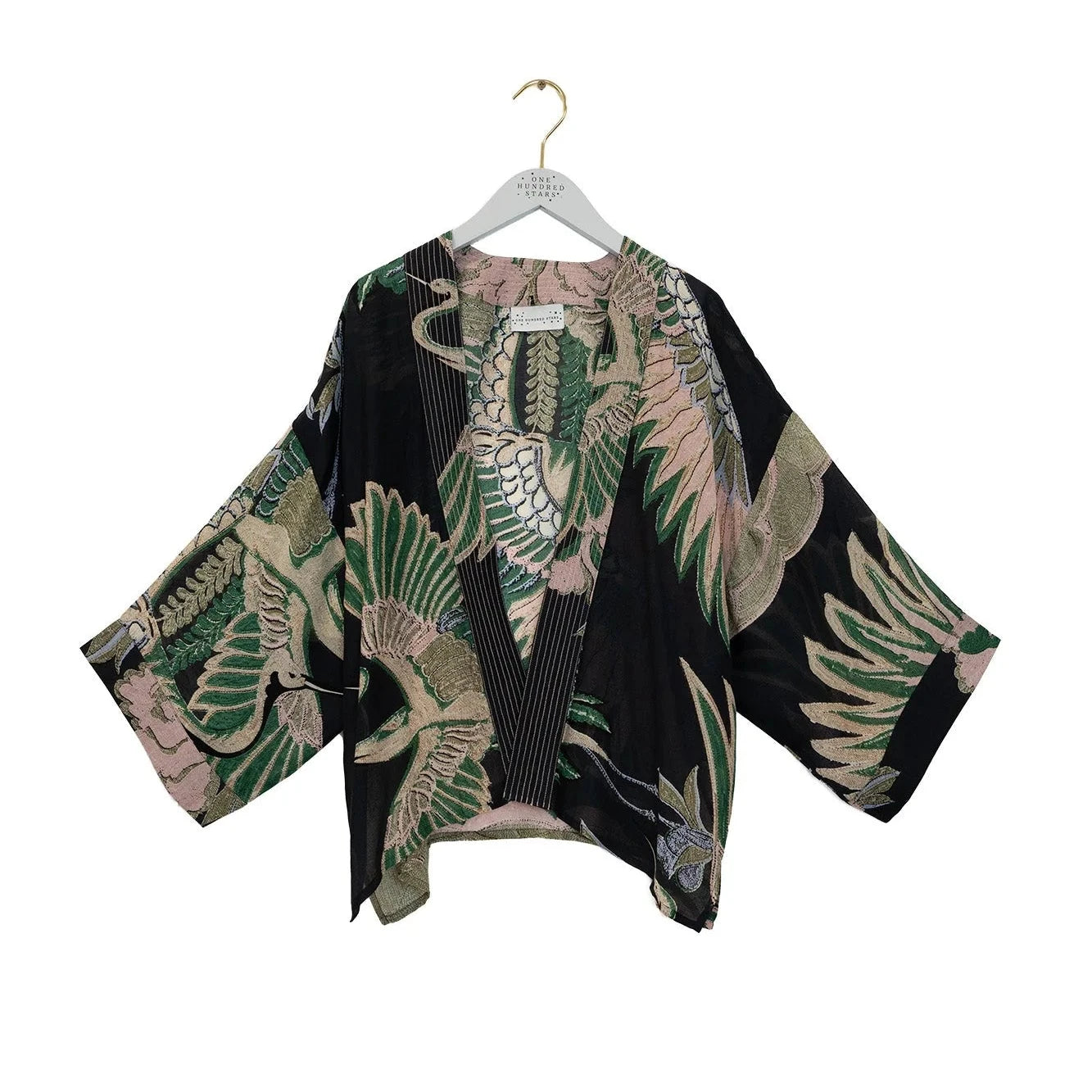 Kimono-style garment with leaf pattern on a hanger against a white background