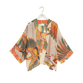 Kimono-style garment with tropical leaf pattern on a white background