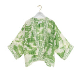 Green and white patterned kimono on a hanger against a white background
