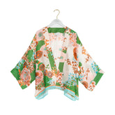 Floral kimono on a hanger against a white background