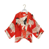 Red kimono with crane design on a white background