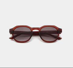 Round frame sunglasses with a red-brown frame and dark lenses, featuring high quality optical hinges and formable temples with a metal core.