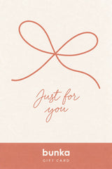 A Bunka gift card featuring a minimalist design with a terracotta ribbon graphic and the words 'Just for you' on a warm cream background, with the Bunka brand name printed in white on a terracotta band at the bottom.
