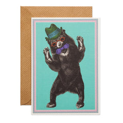 Party Bear Greeting Card -  a bear with a green hat, purple bow tie and red sunglasses. base baby blue